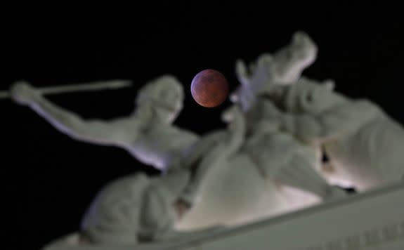 Mandatory Credit: Photo by Rich Pedroncelli/AP/REX/Shutterstock (10069479c) The moon is framed in a statue on the state Capitol during a total lunar eclipse, in Sacramento, Calif. The entire eclipse will exceed three hours. Totality-when the moon's completely bathed in the Earth's shadow-will last an hour. Expect the eclipsed or blood moon, to turn red from the sunlight scattering off Earth's atmosphere California Lunar Eclipse, Sacramento, USA - 20 Jan 2019