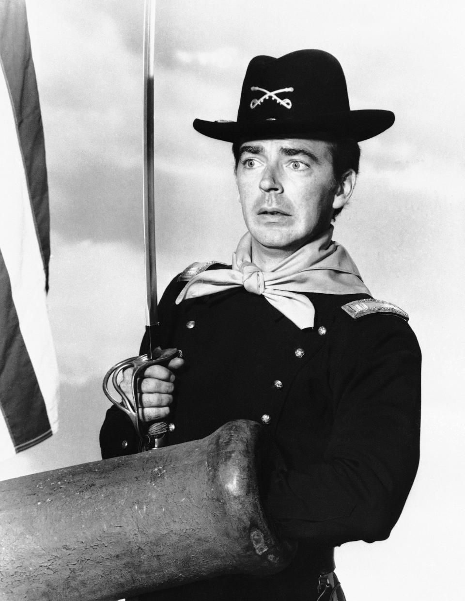 FILE - In a July 1, 1965 file photo, Ken Berry, who plays Captain Wilton Parmenter in a TV series called "F Troop," reaches down the wrong end of cannon in one of the show's episodes. A spokeswoman at Providence St. Joseph in Burbank, Calif., confirmed Berry died Saturday, Dec. 1, 2018. He was 85. (AP Photo, File)