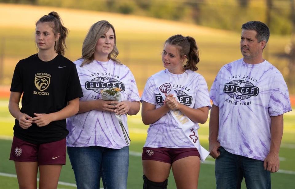 Addi Baxter (right) and older sister Megan on senior night for the Columbia City soccer team. The sisters credit soccer with bringing them even closer together. They were always talking, always laughing with one another.