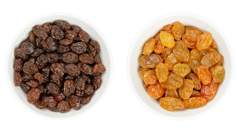 different colored raisins in white bowls