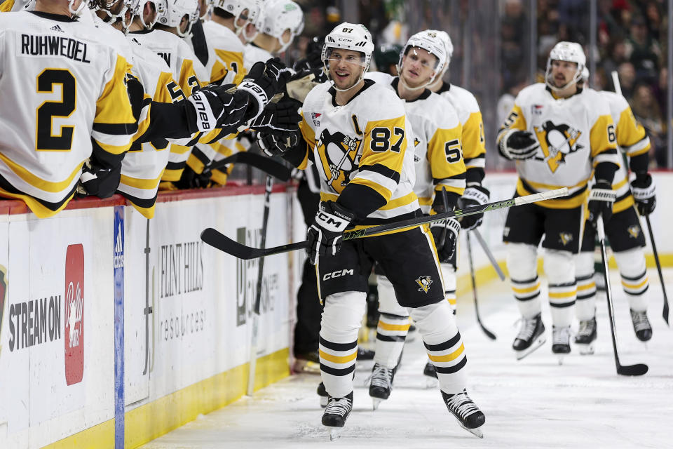 Pittsburgh Penguins center Sidney Crosby (87) is congratulated for his goal against the Minnesota Wild during the third period of an NHL hockey game Friday, Feb. 9, 2024, in St. Paul, Minn. (AP Photo/Matt Krohn)