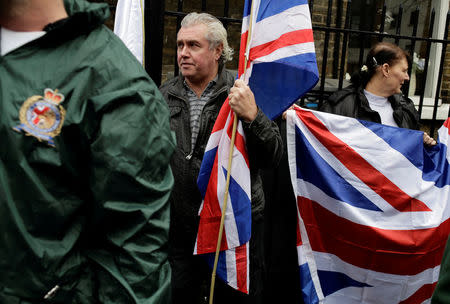 People hold the Union Flag whilst attending a Britain First rally in Rochester, Britain November 15, 2014. Picture taken November 15, 2014. REUTERS/Kevin Coombs