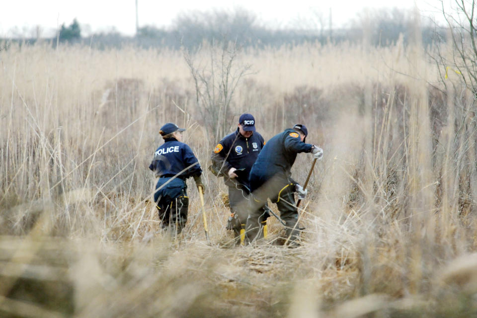 FILE - Crime scene investigators use metal detectors to search a marsh for the remains of Shannan Gilbert, Dec. 12, 2011 in Oak Beach, New York. A Long Island architect has been charged, Friday, July 14, 2023, with murder in the deaths of three of the 11 victims in a long-unsolved string of killings known as the Gilgo Beach murders. (James Carbone/Newsday via AP, Pool, File) (James Carbone / Pool/Newsday via AP file)