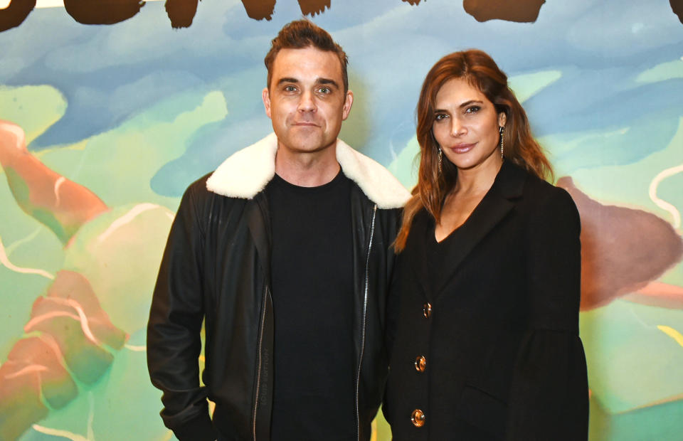 Robbie Williams and Ayda Field have reportedly been invited to the royal wedding. [Photo: Getty]