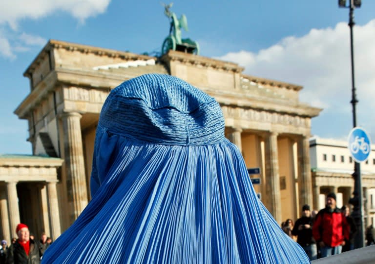 The burka has long been divisive in Germany. Here a woman demonstrates in front of the Brandenburg Gate in Berlin against the Bundeswehr army's deployment in Afghanistan in 2010