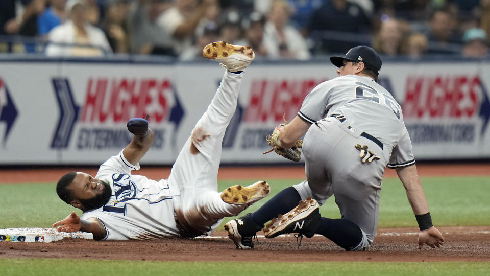 New York Yankees third baseman DJ LeMahieu (26) tags out Tampa Bay Rays' Manuel Margot after he tried to from first to third base on a single by Harold Ramirez during the sixth inning of a baseball game Saturday, May 6, 2023, in St. Petersburg, Fla. (AP Photo/Chris O'Meara)