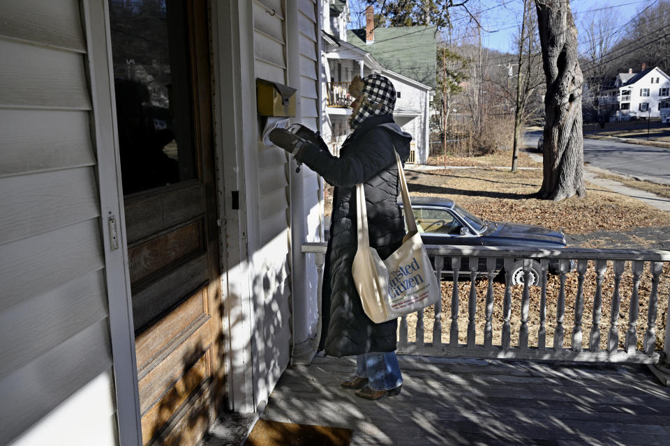 Marie Bonelli, reporter for The Winsted Citizen, delivers the first issue of the paper to homes, Friday, Feb. 3, 2023, in Winsted, Conn. At a time that local newspapers are dying at an alarming rate, longtime activist Ralph Nader is helping give birth to one. Nader put up $15,000 to help launch The Winsted Citizen and hired a veteran Connecticut journalist, Andy Thibault, to put it together. (AP Photo/Jessica Hill)