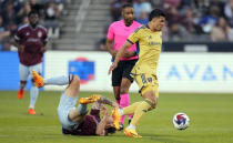 Real Salt Lake defender Brayan Vera, right, collects the ball as Colorado Rapids midfielder Sam Nicholson tumbles to the pitch in the first half of an MLS soccer match, Saturday, May 20, 2023, in Commerce City, Colo. (AP Photo/David Zalubowski)