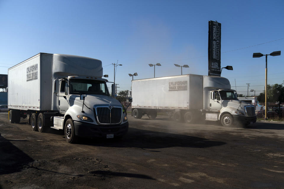 Two student drivers practice driving in reverse at California Truck Driving Academy in Inglewood, Calif., Monday, Nov. 15, 2021. Amid a shortage of commercial truck drivers across the U.S., a Southern California truck driving school sees an unprecedented increase in enrollment numbers. The increase is big enough that the school is starting an evening class to meet the demand, according to Tina Singh, owner and academy director of California Truck Driving Academy. "I think that's only going to continue because there's a lot of job opportunities. We have over 100 active jobs on our job board right now," said Singh. The companies that normally would not hire drivers straight out of school are "100 percent" willing to hire them due to shortage issues, the director added. (AP Photo/Jae C. Hong)