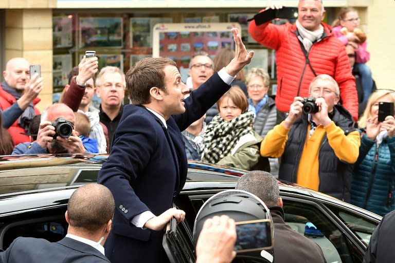 French centrist presidential candidate Emmanuel Macron greets supporters as France votes in the first round of an unpredictable election