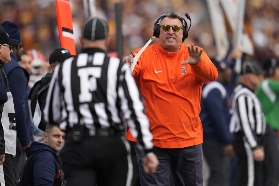 Illinois head coach Bret Bielema, right, gestures toward a referee during the first half of an NCAA college football game against Minnesota, Saturday, Nov. 4, 2023, in Minneapolis. (AP Photo/Abbie Parr)