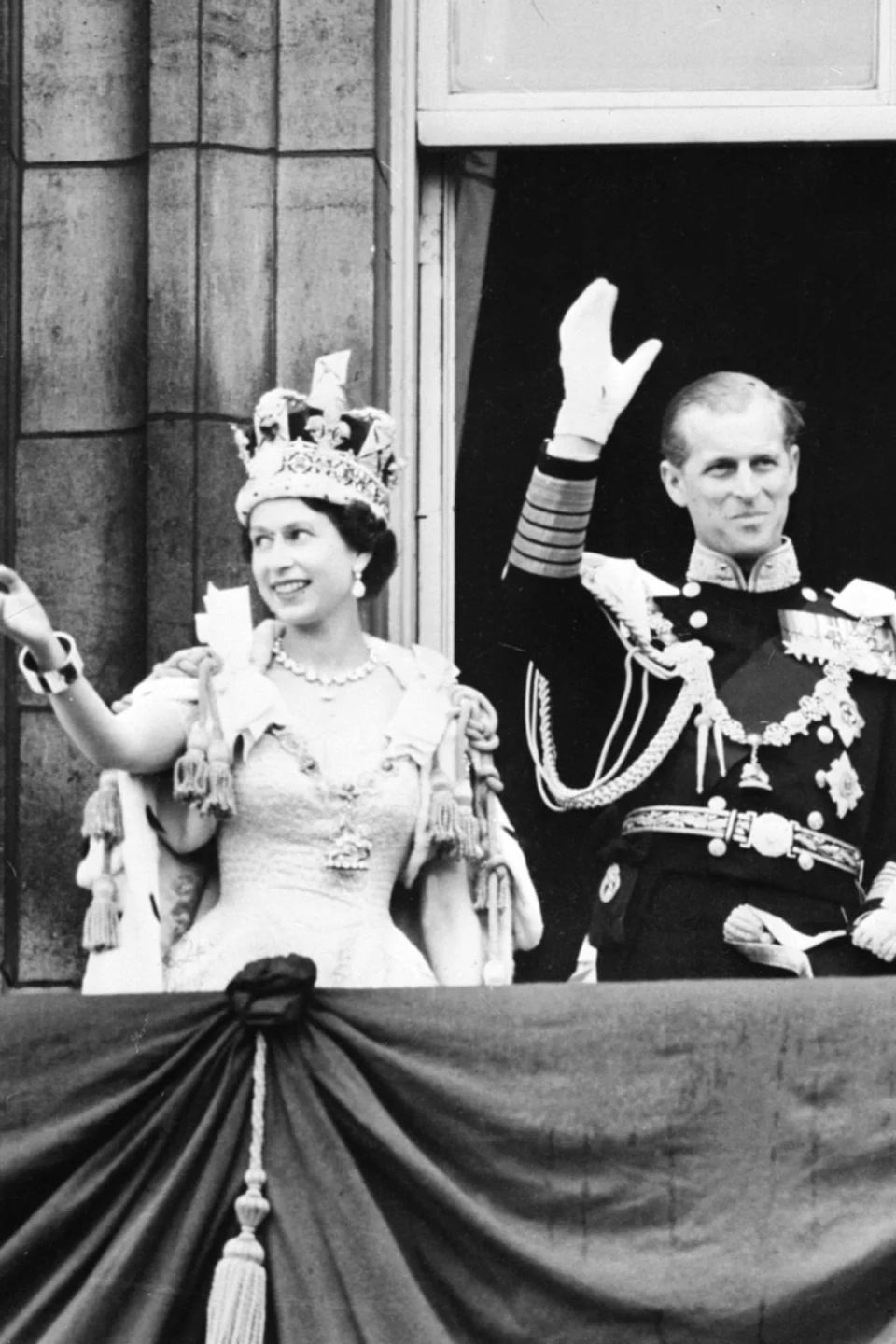 June 2, 1953: Queen Elizabeth accompanied by Prince Philip waves to the crowd after being crowned solemnly at Westminter Abbey (AFP/Getty Images)