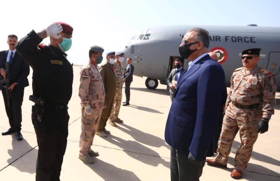 TAKES OUT REFERENCE TO DESIGNATE - Iraqi Prime Minister Mustafa al-Kahdimi, right, arrives to Mosul, Iraq, Wednesday, June 10, 2020. (Iraqi Prime Minister Media Office, via AP)