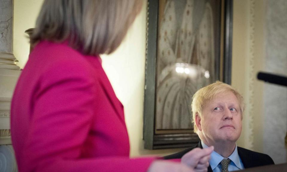 Boris Johnson listens to Truss during a panel event and reception to mark International Women’s Day in 2020.