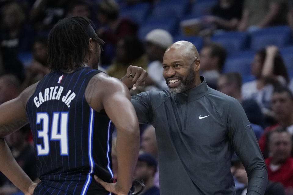 Orlando Magic head coach Jamahl Mosley talks to center Wendell Carter Jr. (34) in the first half of an NBA preseason basketball game against the New Orleans Pelicans in New Orleans, Tuesday, Oct. 10, 2023. (AP Photo/Gerald Herbert)