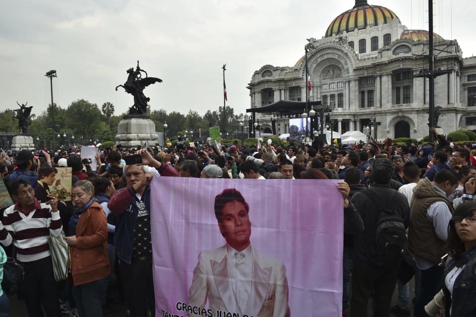 People gather outside the Palace of Fine Arts to pay tribute to Mexico's late Latin music legend Juan Gabriel.