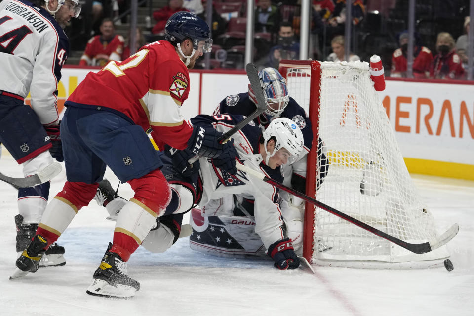 Columbus Blue Jackets defenseman Tim Berni, right, defends the goal during the second period of an NHL hockey game against the Florida Panthers, Tuesday, Dec. 13, 2022, in Sunrise, Fla. (AP Photo/Lynne Sladky)