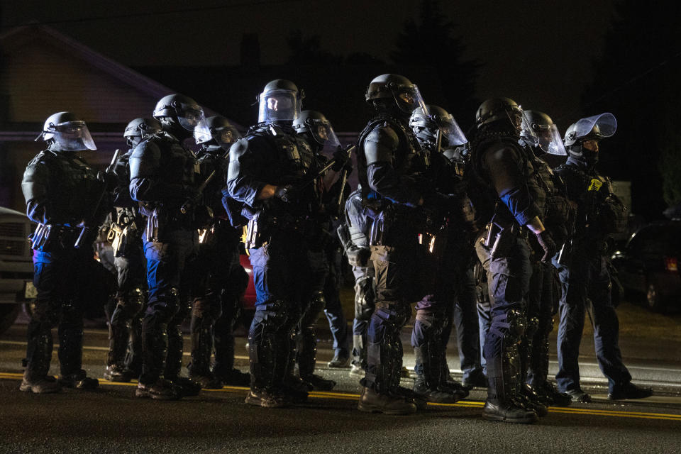 Portland police take control of the streets after making arrests on the scene of the nightly protests at a Portland police precinct on Sunday, Aug. 30, 2020 in Portland, Ore. Oregon State Police will return to Portland to help local authorities after the fatal shooting of a man following clashes between President Donald Trump supporters and counter-protesters that led to an argument between the president and the city's mayor over who was to blame for the violence.(AP Photo/Paula Bronstein)