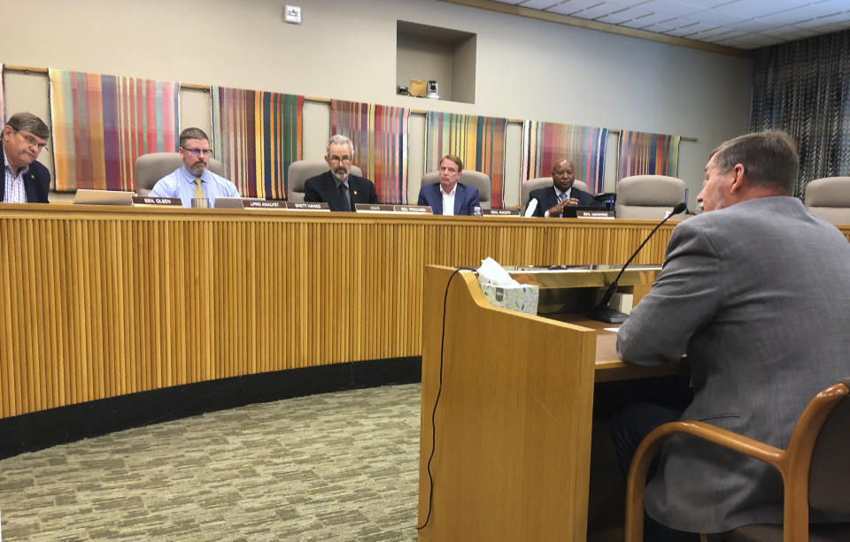 State Sen. Brian Boquist reads a statement on Monday, July 8, 2019, to the Senate special committee on conduct in Salem, Ore. An independent investigator told the Oregon Senate committee Monday that Boquist's threats against state police and the Senate president created an unsafe work environment and suggested he be at least temporarily banned from the Capitol. (AP Photo/Andrew Selsky)