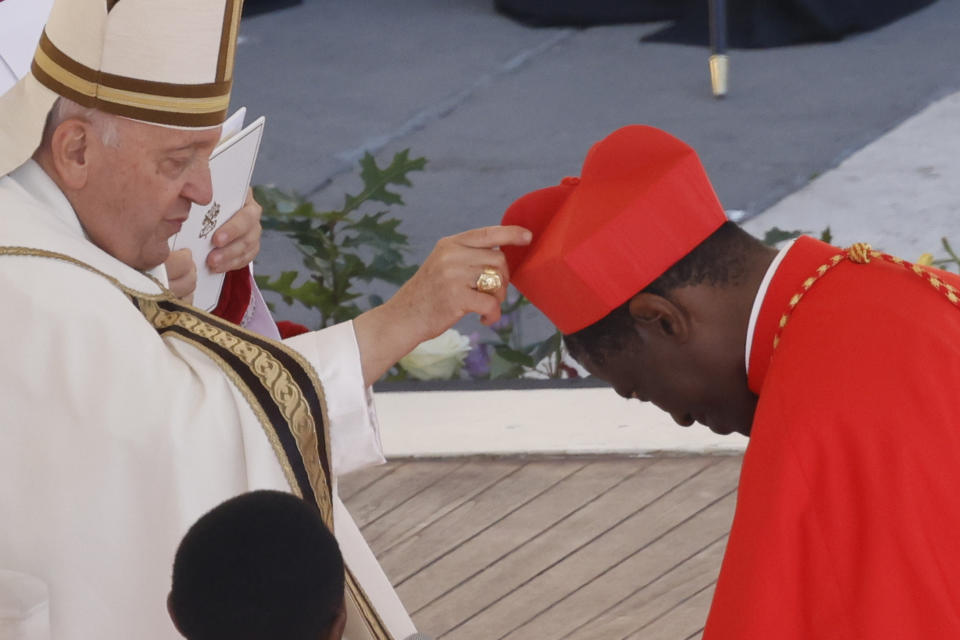 Newly elected Cardinal Protase Rugambwa, coadjutor archbishop of Tabora, Tanzania, right, receives his biretta from Pope Francis as he is elevated in St. Peter's Square at The Vatican, Saturday, Sept. 30, 2023. (AP Photo/Riccardo De Luca)