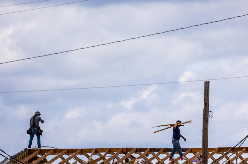 People repair a roof damaged the previous day, by a tornado in Slidell., La., Thursday, April 11, 2024. (Chris Granger/The Times-Picayune/The New Orleans Advocate via AP)