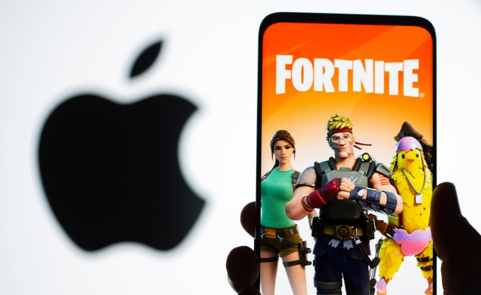 Fortnite game graphic is displayed on a smartphone in front of Apple logo in this illustration taken May 2, 2021. REUTERS/Dado Ruvic/Illustration
