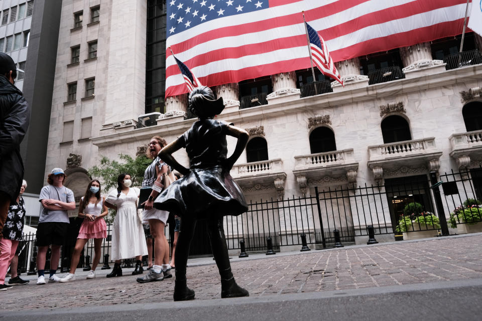 NEW YORK, NEW YORK - AUGUST 10: People walk by the Fearless Girl statue outside of the New York Stock Exchange (NYSE) on August 10, 2021 in New York City. Markets were up in morning trading as investors look to a rare bipartisan effort in the Senate to pass a massive infrastructure bill that, if passed, will infuse billions into the American economy. (Photo by Spencer Platt/Getty Images)