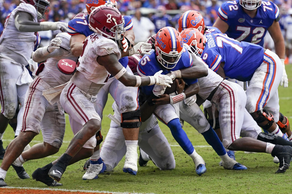 Florida quarterback Emory Jones (5) pushes his way past the Alabama defense including defensive back DeMarcco Hellams (2) for a 5-yard touchdown run during the second half of an NCAA college football game, Saturday, Sept. 18, 2021, in Gainesville, Fla. (AP Photo/John Raoux)