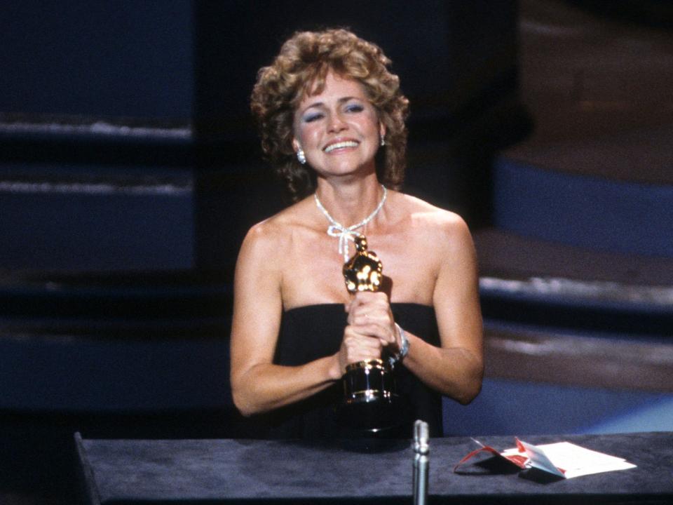 Sally Fields accepts the Best Performance by an Actress in a Supporting Role award for "Places in the Heart" onstage during the Oscars on March 25, 1985 in Hollywood, California