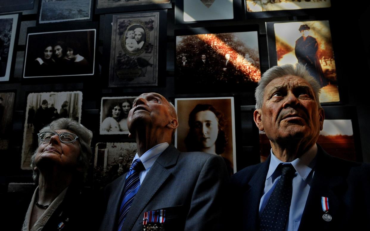 Holocaust rescuers (aka the ‘Polish Righteous’), from left, Alicja Schnepf-Szczepaniak, Jozef Walaszczyk, and Tadeusz Stankiewicz in the Tower of Faces exhibit at the US Holocaust museum before Remembrance event in 2009 at the Capitol with President Obama - Michael Williamson/The Washington Post via Getty Images