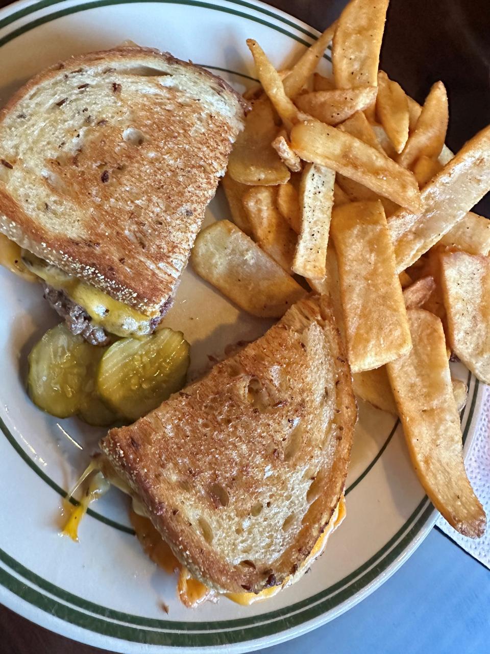 Steak fries next to a sandwich.