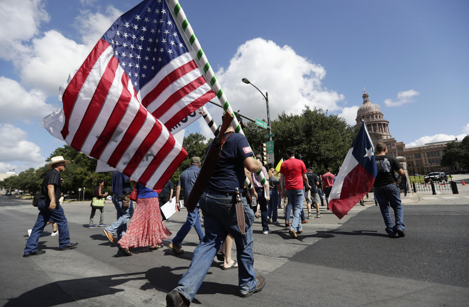 Gun rights advocates gather outside the Texas Capitol where Texas Gov. Greg Abbott held a round table discussion, Thursday, Aug. 22, 2019, in Austin, Texas. Abbott is meeting in Austin with officials from Google, Twitter and Facebook as well as officials from the FBI and state lawmakers to discuss ways of combatting extremism in light of the recent mass shooting in El Paso that reportedly targeted Mexicans. (AP Photo/Eric Gay)