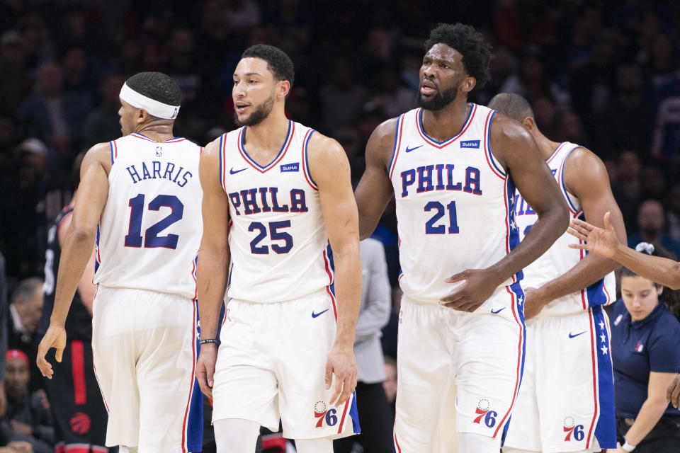 Tobias Harris #12, Ben Simmons #25, and Joel Embiid #21 of the Philadelphia 76ers react against the Toronto Raptors at Wells Fargo Center on December 8, 2019 in Philadelphia, Pennsylvania.