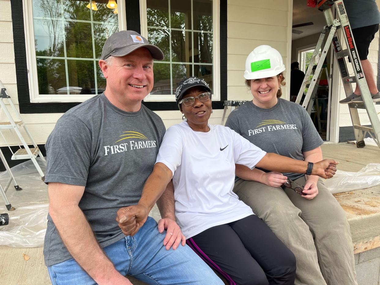 (Left) Brian Williams, First Farmers of Columbia chairman and CEO and (right) Jill Giles, chief accounting officer, volunteer to help construct the new home of Shirley Wilson, middle, as part of a Habitat for Humanity Williamson-Maury homeownership program.