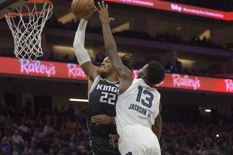 Sacramento Kings forward Richaun Holmes (22) scores as Memphis Grizzlies forward Jaren Jackson Jr. (13) defends during the first quarter of an NBA basketball game in Sacramento, Calif., Thursday, Jan. 2, 2020. (AP Photo/Randall Benton)