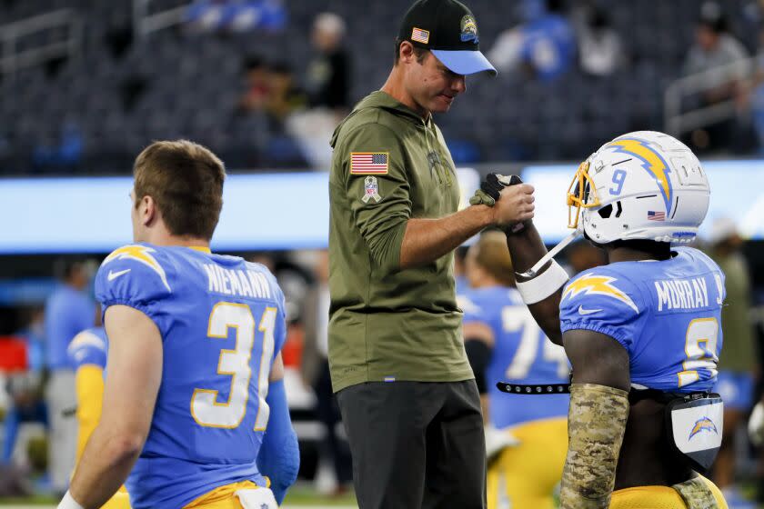 Los Angeles, CA - November 20: Los Angeles Chargers head coach Brandon Staley (center) meets with linebacker Kenneth Murray Jr. (9) before the game against the Kansas City Chiefs at SoFi Stadium on Sunday, Nov. 20, 2022 in Los Angeles, CA. (Robert Gauthier / Los Angeles Times)
