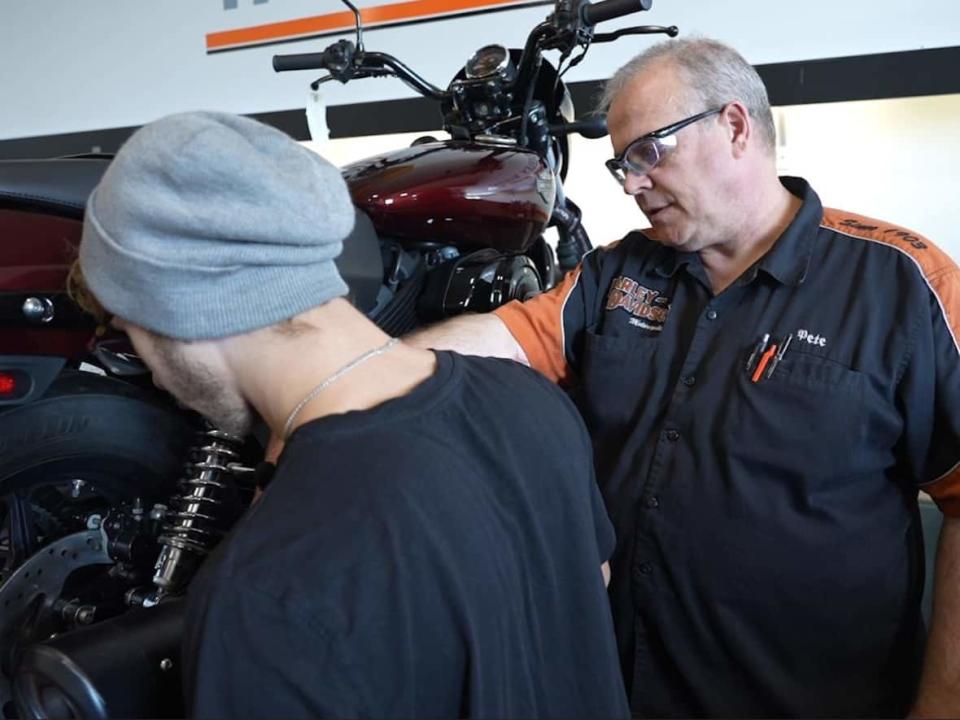 Peter Sellers, right, completed the Harley-Davidson Technician Certificate in 1992 and later returned as an instructor. (Luke Ettinger/CBC - image credit)