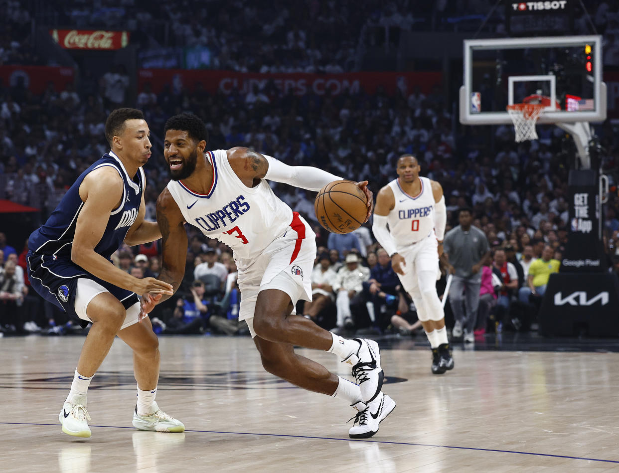 LOS ANGELES, CALIFORNIA - MAY 01:  Paul George #13 of the LA Clippers controls the ball against Dante Exum #0 of the Dallas Mavericks during game five of the Western Conference First Round Playoffs at Crypto.com Arena on May 01, 2024 in Los Angeles, California.  NOTE TO USER: User expressly acknowledges and agrees that, by downloading and/or using this photograph, user is consenting to the terms and conditions of the Getty Images License Agreement.  (Photo by Ronald Martinez/Getty Images)