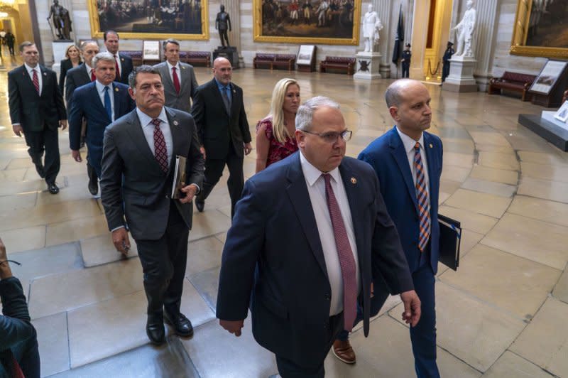 Sergeant at Arms of the House of Representatives William McFarland (L) and Acting Clerk of the House Kevin McCumber lead 11 House Republican impeachment managers as they deliver the Articles of Impeachment against Homeland Security Secretary Alejandro Mayorkas to the Senate through the U.S. Capitol Rotunda in Washington, D.C., on Tuesday. Photo by Bonnie Cash/UPI