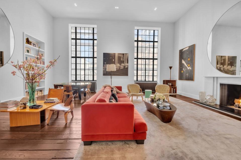 The double-height living room with original casement windows. Tina Gallo for Douglas Elliman