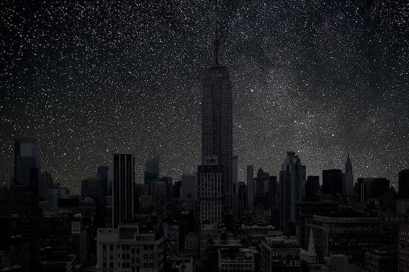 Starlight shines through the windows of the Empire State Building in this photo of a darkened New York City.