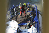 FILE- In this Tuesday, June 11, 2019, file photo a diver looks for bodies on the sunken ship in Budapest, Hungary. Preparations are underway for commemorations to be held on the first anniversary of the May 29, 2019, mishap on the Danube River in which a sightseeing boat carrying mostly tourists from South Korea sank after a collision with a river cruise ship. Just seven of the 33 South Korean tourists aboard the Hableany (Mermaid) survived the nighttime collision. (Balazs Mohai/MTI via AP)