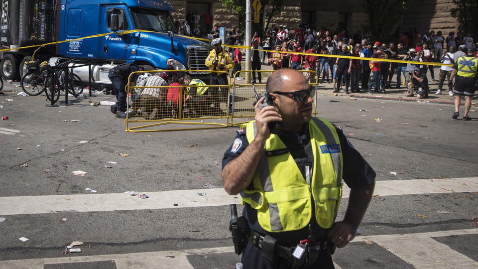 First responders attended to an injured person after shots were fired during the Toronto Raptors NBA Championship victory celebration near Nathan Phillips Square in Toronto on Monday, June 17, 2019. THE CANADIAN PRESS/ Tijana Martin