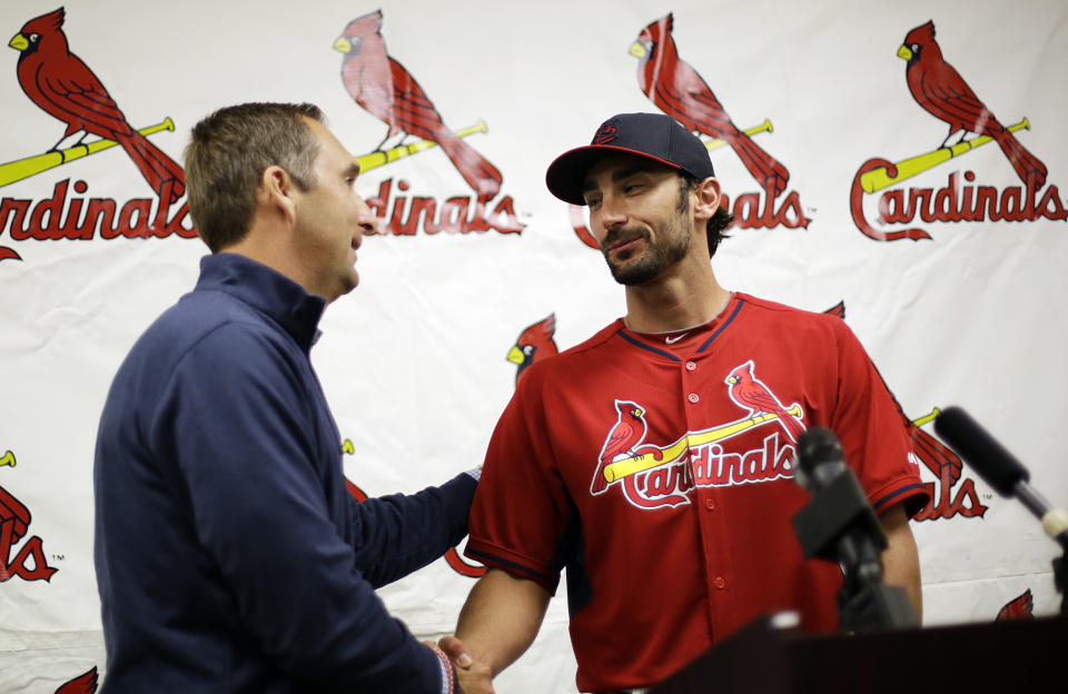 St. Louis Cardinals' Matt Carpenter, right, shakes hands with Sr. Vice President and General Manager John Mozeliak, left, at a news conference at the team's spring training baseball facility, Saturday, March 8, 2014, in Jupiter, Fla. The Cardinals announced Saturday that they have agreed to a six-year contract extension with Carpenter for $52 million. (AP Photo/David Goldman)