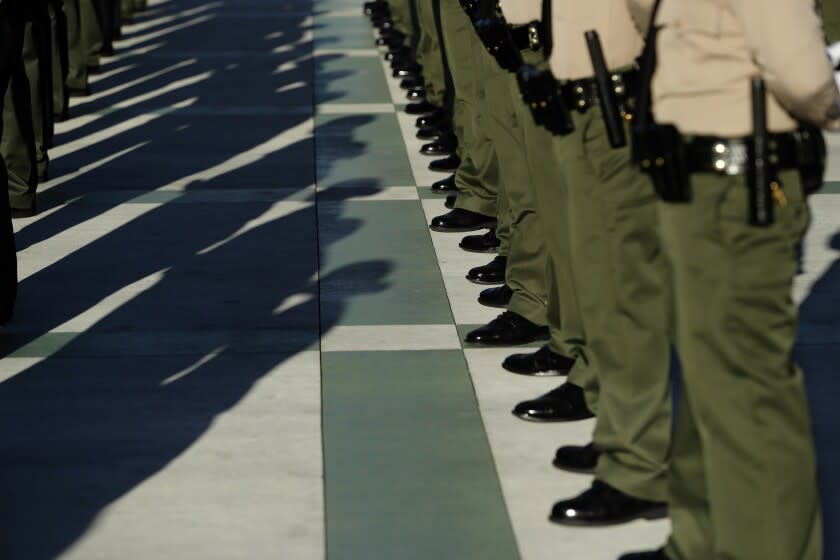 Los Angeles County Sheriff's deputies stand at attention during the inspection portion of their graduation