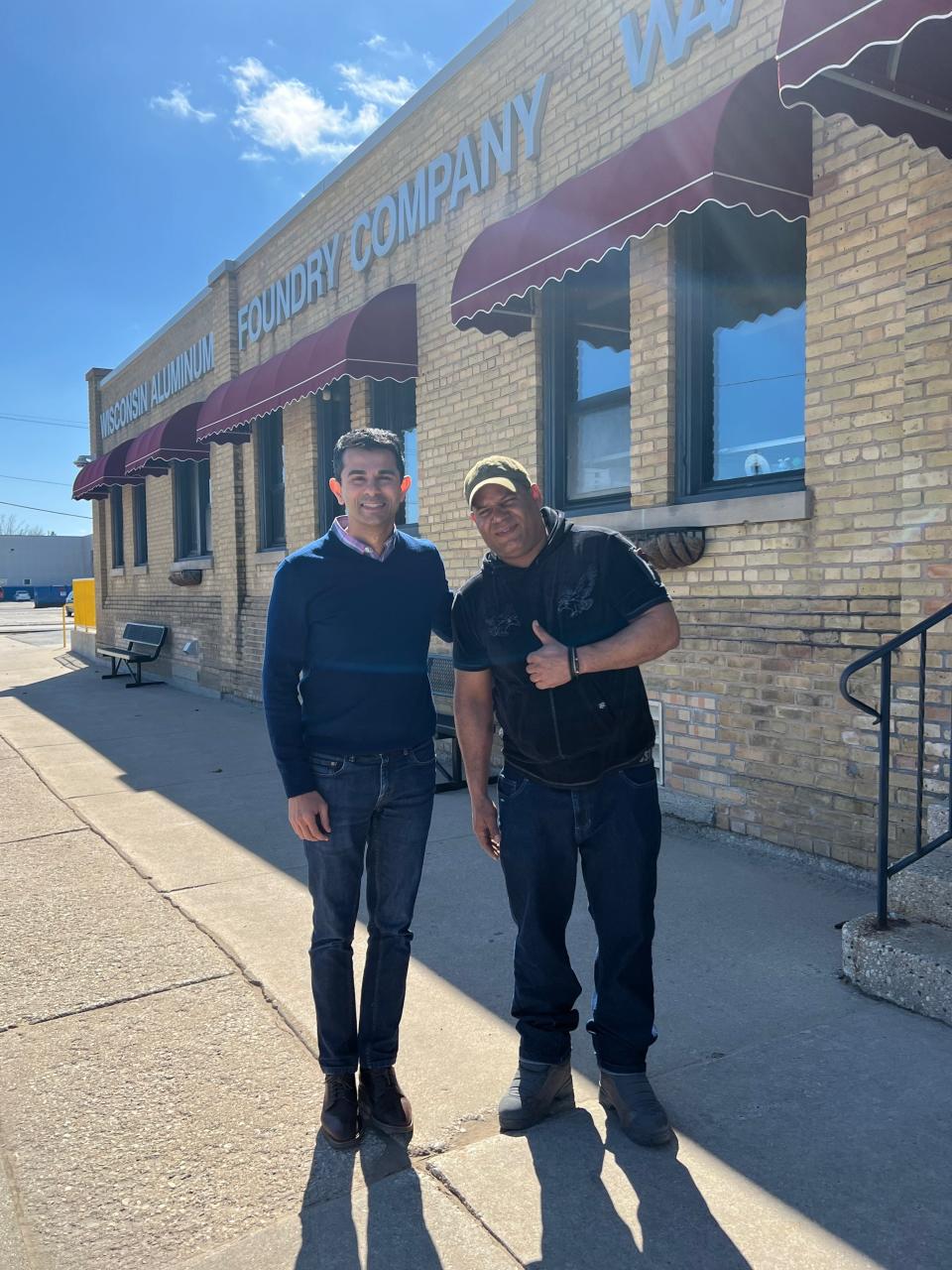 Wisconsin Aluminum Foundry CEO Sachin Shivaram, left, with Morgan Sarduy outside the company's downtown Manitowoc facility.