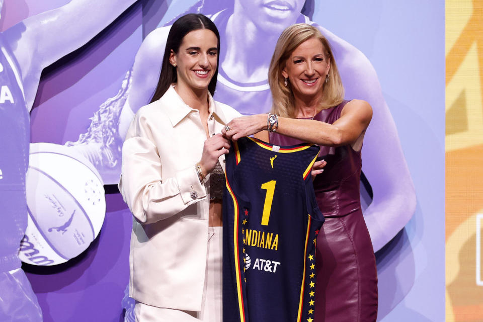 Caitlin Clark poses with WNBA Commissioner Cathy Engelbert after Indiana Fever selects her with first pick in 2024 WNBA draft. (Sarah Stier / Getty Images)