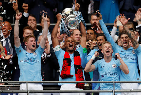 Soccer Football - FA Cup Final - Manchester City v Watford - Wembley Stadium, London, Britain - May 18, 2019 Manchester City's Vincent Kompany lifts the trophy as they celebrate after winning the FA Cup Action Images via Reuters/John Sibley