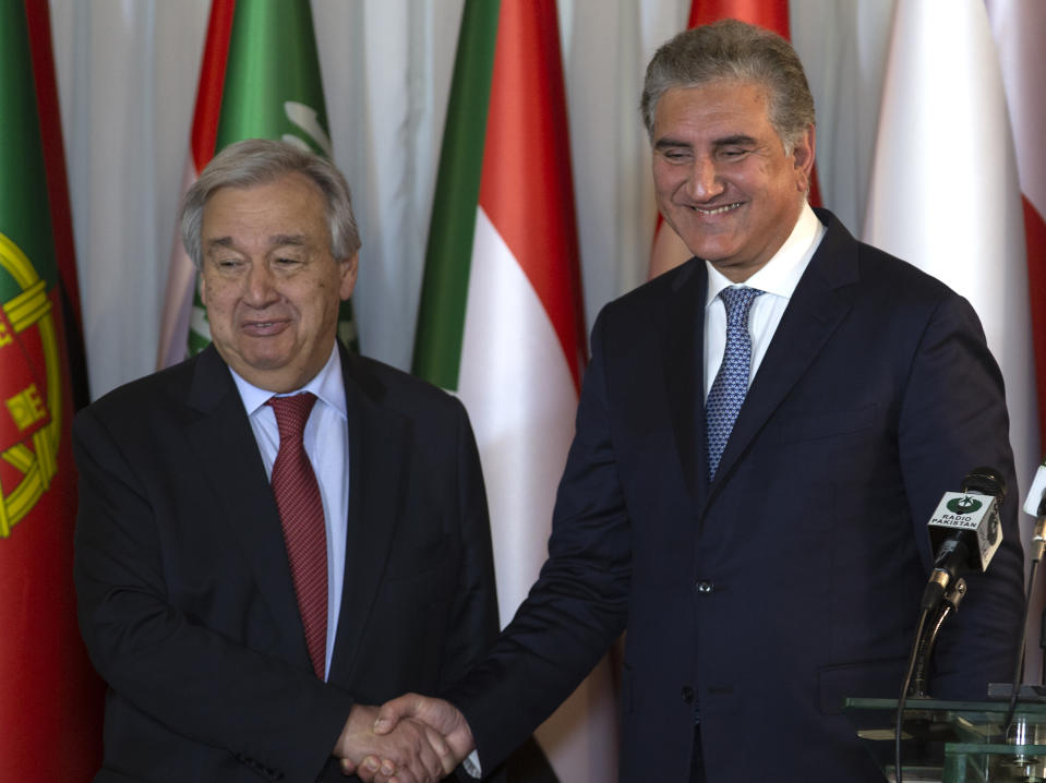 In this Sunday, Feb. 16, 2020 photo, U.N. Secretary-General Antonio Guterres, left, shakes hands with Pakistani Foreign Minister Shah Mahmood Qureshi after a joint press conference at the Foreign Ministry in Islamabad, Pakistan. After 40 years, more than 1.5 million Afghan refugees still live in neighboring Pakistan. They feel abandoned by their own government, increasingly unwelcome in their reluctant host country and ignored by the United Nations. Pakistan hosting a conference on Afghan refugees, attended by Guterres. (AP Photo/B.K. Bangash)