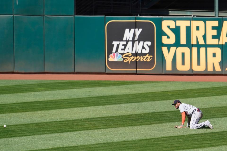 Detroit Tigers center fielder Victor Reyes watches as Oakland Athletics' Matt Olson's double rolls in front of him during the ninth inning in Oakland, Calif., on Sunday, April 18, 2021.